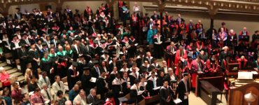 A photo of hundreds of graduates at the University of Divinity March 2018 ceremony, taken from above looking down, from the balcony of St Michael's Uniting church