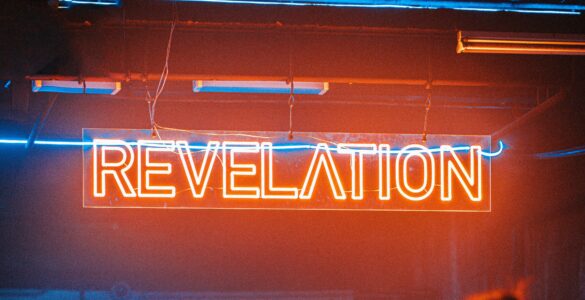 a neon sign reads revelation in red